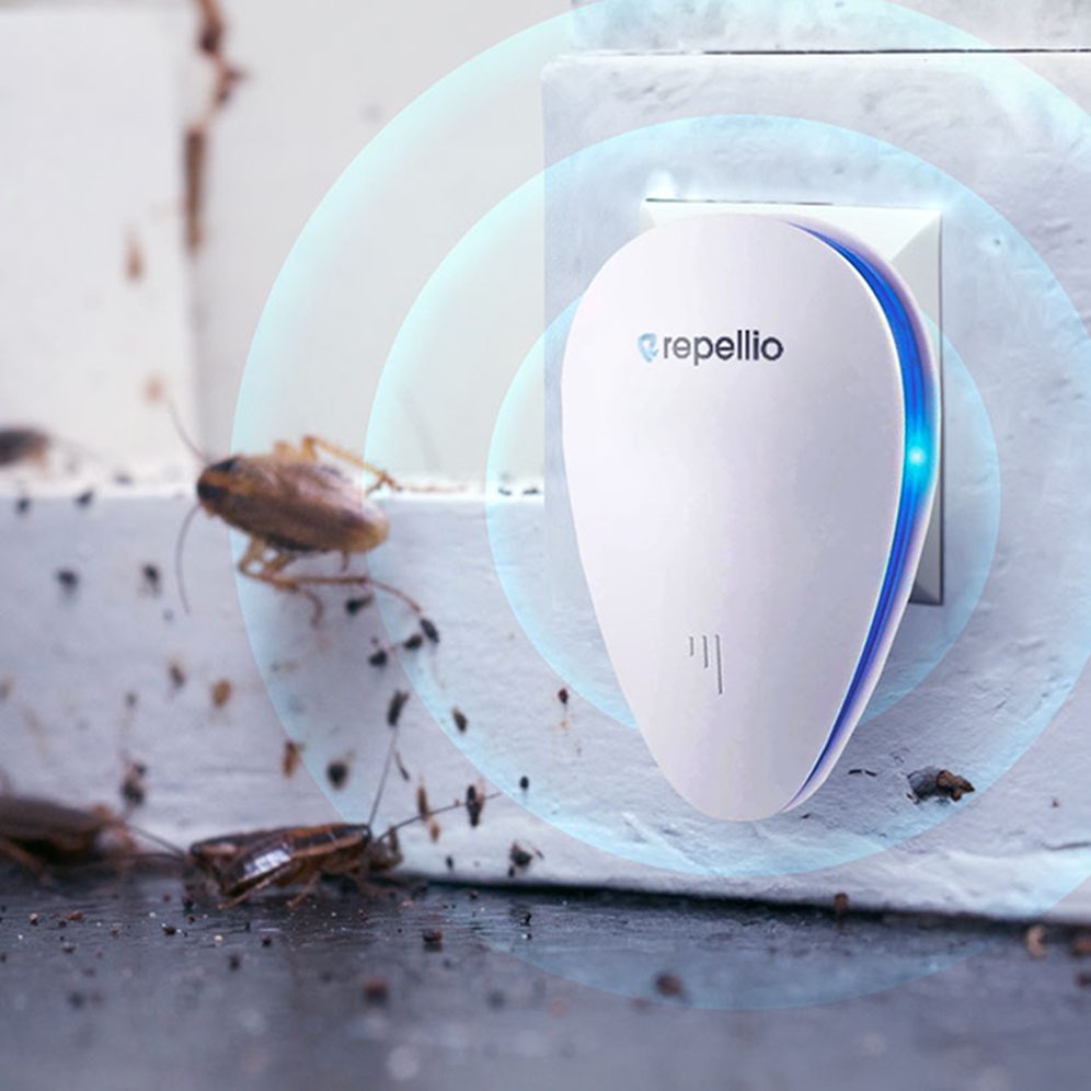 Repellio in a wall socket sending out sound waves towards a cockroach